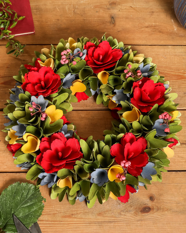colourful red rose wreath wreath on a wooden table