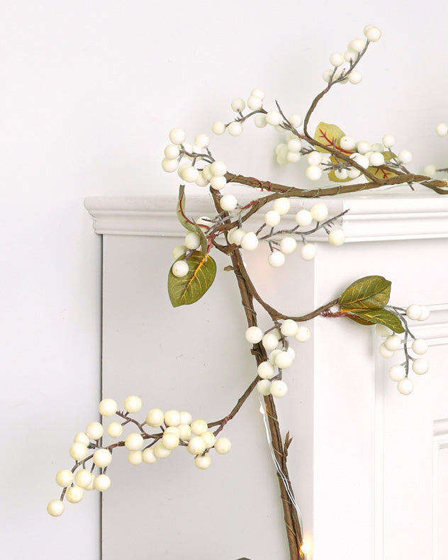 white berry christmas garland on mantle