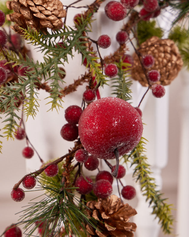 red and green garland wrapped around banister