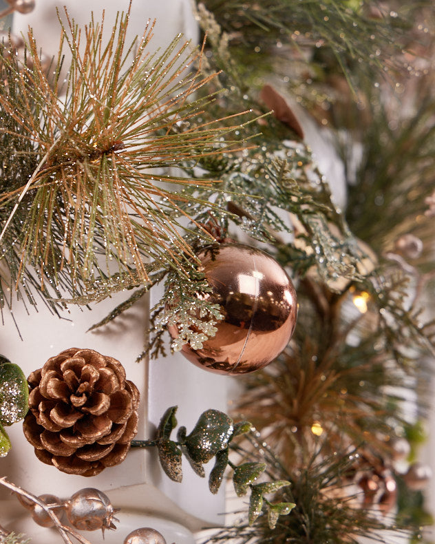 Shiny bronze bauble and pinecone