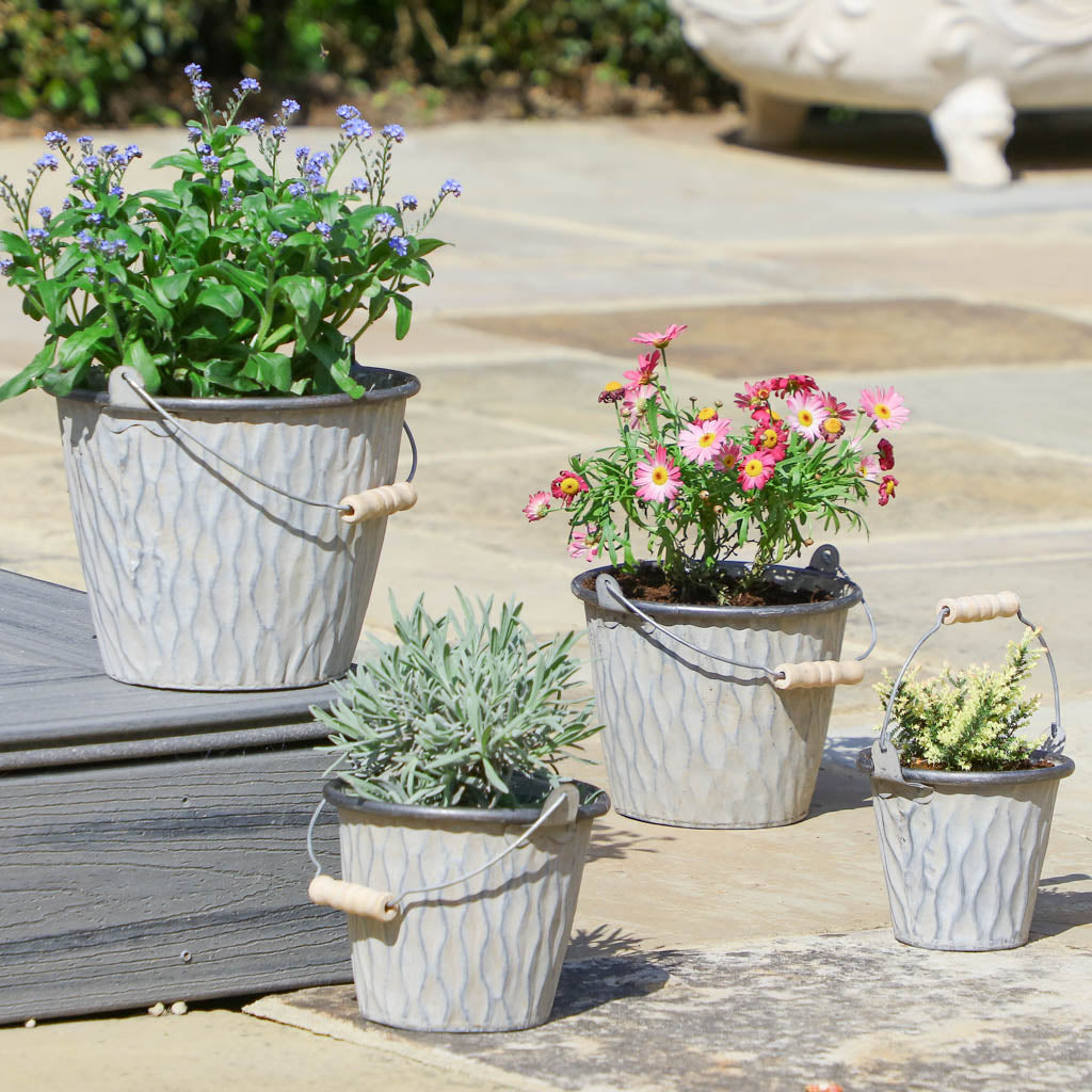 4 metal bucket planters